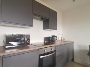 a kitchen with a counter top with a microwave at The Loft in Bradford