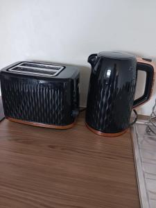 a black toaster and a toaster sitting on a counter at The Loft in Bradford