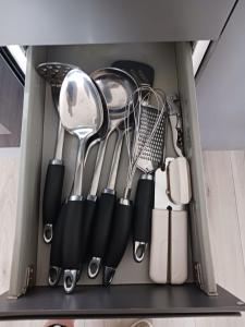 a drawer full of kitchen utensils in a cabinet at The Loft in Bradford