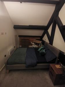 a bedroom with a large bed in a attic at The Loft in Bradford