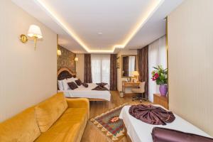 A bed or beds in a room at Aprilis Gold Hotel - Special Category