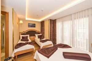 A bed or beds in a room at Aprilis Gold Hotel - Special Category