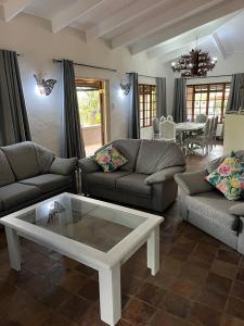 a living room with couches and a coffee table at Mi Casita in Graskop