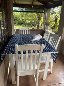 a blue and white table and chairs on a porch at Mi Casita in Graskop