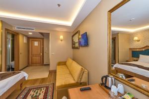 A bed or beds in a room at Aprilis Gold Hotel - Special Category