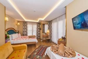 A bed or beds in a room at Aprilis Gold Hotel - Special Category