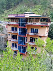 a building with lots of windows on the side of a hill at Hotel Red Roof & Restaurant in Abbottabad