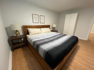 a bedroom with a large bed with two night stands at Letitia Heights !B Spacious and Quiet Private Bedroom with Shared Bathroom in Barrie