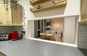 a kitchen with a table and a dining room at Contemporary-styled 3-Bed House in Buckinghamshire