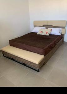 a bed with two pillows on it in a room at قريه امواج الساحل الشمالى in Sīdī ‘Abd ar Raḩmān