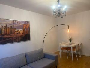 a living room with a couch and a table at Charming Downtown Gem in Linköping
