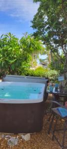 a large bath tub sitting next to a table at The Butterfly Cottage in Marathon