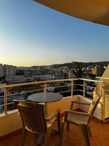 a table and chairs on a balcony with a view at AMI apartament in Vlorë