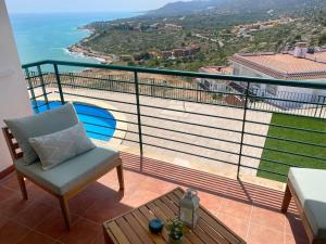 a balcony with a chair and a view of the ocean at Ítaca Apartment Peñiscola in Peñíscola