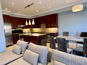 a kitchen with a couch and a table with chairs at Cozy 5 Bedroom House Mississauga in Mississauga