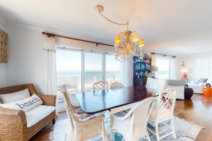 a dining room with a table and chairs and the ocean at Sea Cliff Cottage in Lincoln City