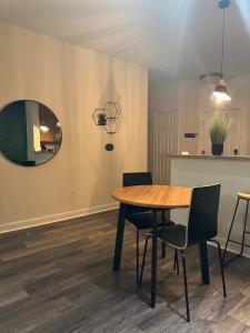 a dining room with a table and chairs and a mirror at EasyStays Alexandria in Alexandria