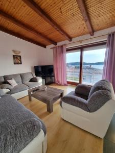 a living room with two couches and a table at Apartments with a parking space Palit, Rab - 4983 in Rab