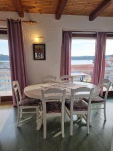 a white table and chairs in a room with a window at Apartments with a parking space Palit, Rab - 4983 in Rab