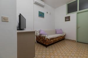 a living room with a couch and a tv at Apartments by the sea Sumpetar, Omis - 949 in Jesenice