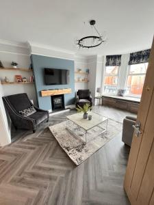 a living room with a couch and a table at The Dunes, Lytham St Annes in Lytham St Annes