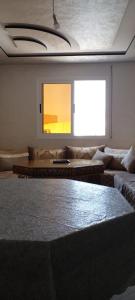 a living room with a couch and a table at Al Hoceima Badess in Al Hoceïma