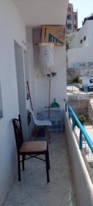a chair and a table on a balcony at Al Hoceima Badess in Al Hoceïma