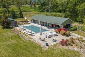 an aerial view of a house with a swimming pool at SummerHill Ranch at Grand Lake 8bed/10bath in Grove