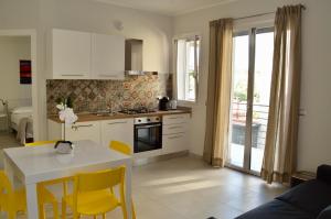 a kitchen and dining room with a table and chairs at Home 13 in San Gregorio di Catania