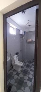 a bathroom with a toilet and a sink at Nhật Lệ Oyster House in Dong Hoi