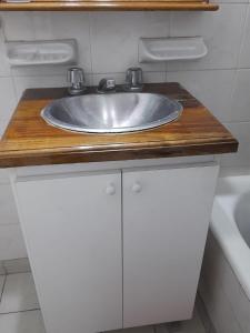 a bathroom counter with a sink on a wooden counter top at Departamento Plaza Colón, Mar del Plata in Mar del Plata