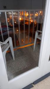 a view of a window with two chairs in it at Departamento Plaza Colón, Mar del Plata in Mar del Plata