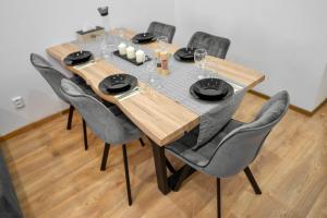 a dining room table with chairs and a table and chairsktop at Vila Antonio in Prague