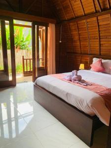 a bedroom with a bed with towels on it at Volcano Valley in Kintamani