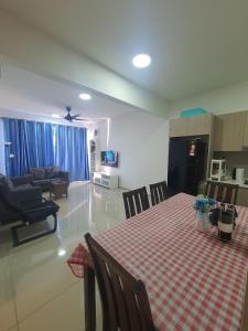 a kitchen and living room with a table and a couch at Gravit 8 , Ashino in Klang