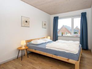a bedroom with a bed and a large window at Holiday home Harboøre XXXV in Harboør