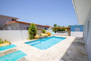a swimming pool in the backyard of a house at R&V Combate Beach House, 2nd Floor with Pool in Cabo Rojo