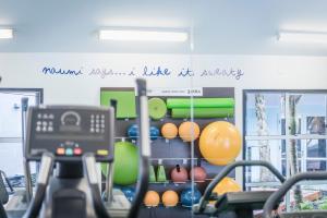 a gym with a bunch of exercise equipment in a room at Naumi Auckland Airport Hotel in Auckland