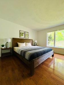 a bedroom with a bed and a large window at Letitia Heights !G Stylish and Spacious Private Bedroom with Shared Bathroom in Barrie