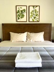 un grande letto con due immagini sul muro di Letitia Heights !G Stylish and Spacious Private Bedroom with Shared Bathroom a Barrie