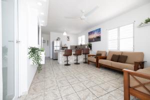 a living room with a couch and a kitchen at R&V Combate Beach House, 2nd Floor with Pool in Cabo Rojo