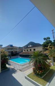 vistas a la piscina desde el balcón de un edificio en Quintal do forte en Praia Grande