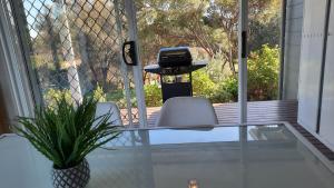 a glass table with two chairs and a printer on a porch at River-Tide Retreat in American River