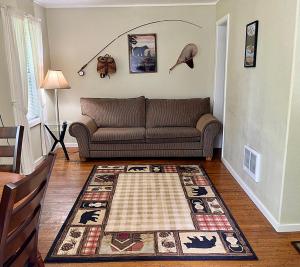 a living room with a couch and a rug at The Cascade Motel in Cascade Locks