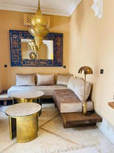 a living room with a couch and a table at Riad Casa nomad in Marrakesh