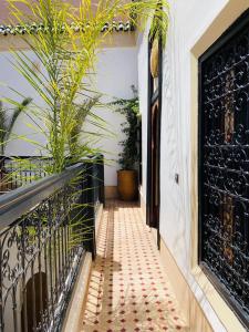 a balcony with a black gate and some plants at Riad Casa nomad in Marrakesh