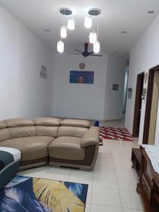 a living room with a couch and a ceiling at D'tasek Homestay Gua Musang in Gua Musang