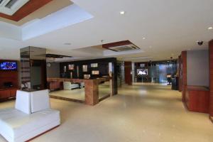 a large room with a lobby with a table in it at Hotel O2 Oxygen in Kolkata