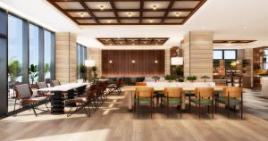 a dining room with tables and chairs and windows at AQA Hotel Premium in Saku
