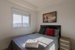 a bedroom with a large bed and a window at Sunset Studio - GRU in Guarulhos